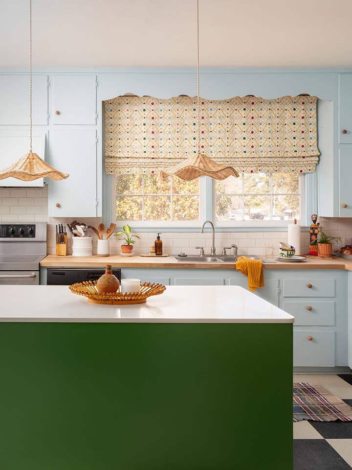 Kitchen with blue cabinets and green island