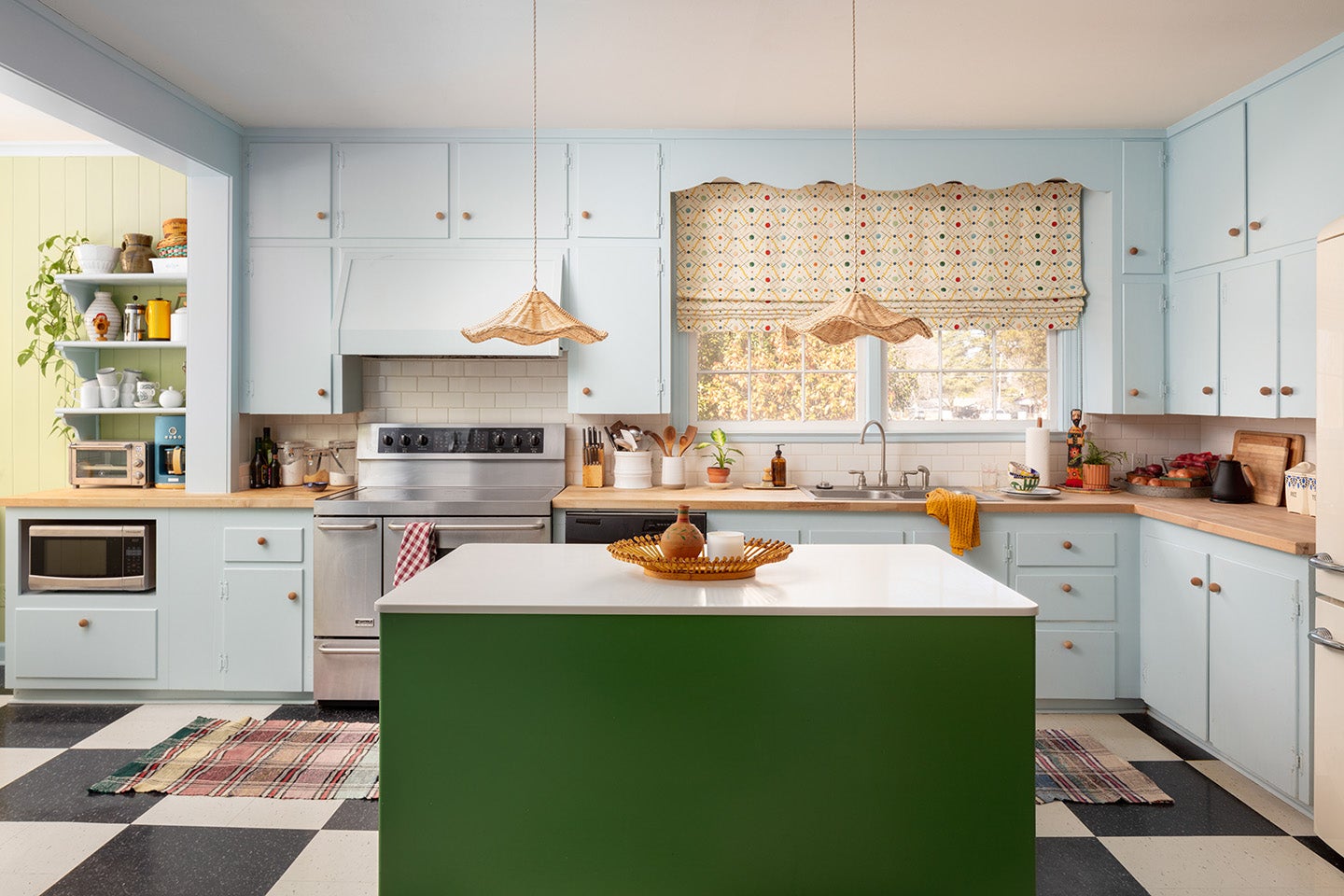 Kitchen with blue cabinets and green island