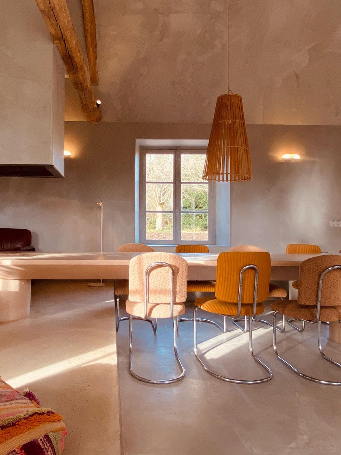 dining area and living room, pink concrete table and fireplace